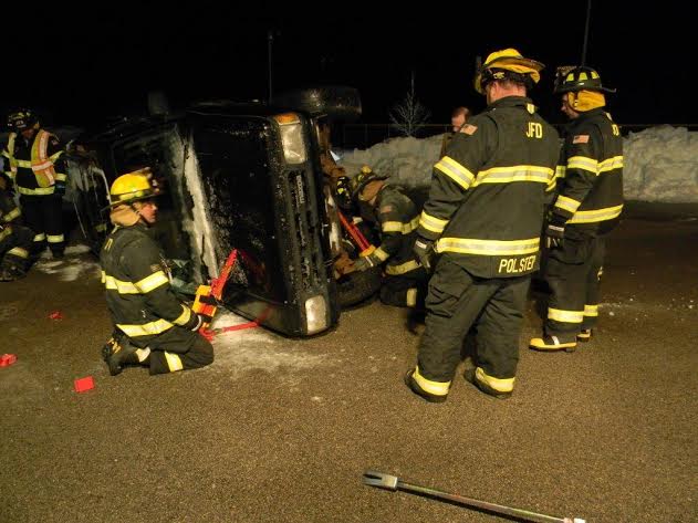 Jacksonport firefighters training in winter at a simulated auto accident.